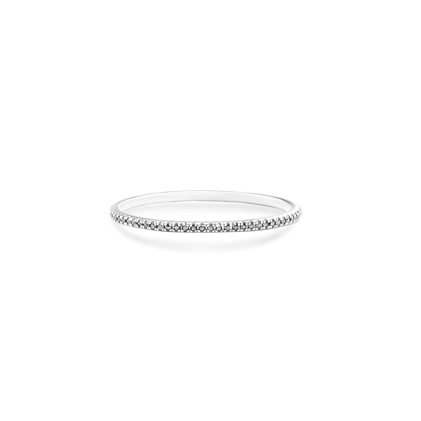 14 Karat White Gold Ring with Black Diamonds in One Row Laying Flat On Flat White Table