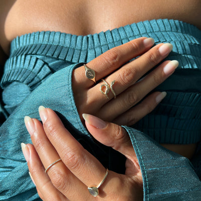 Hand model wearing a yellow gold textured snake ring.