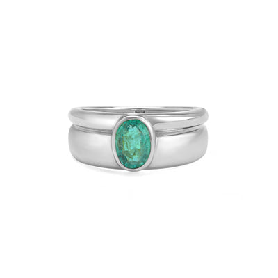 white  gold ring with emerald center stone on white background