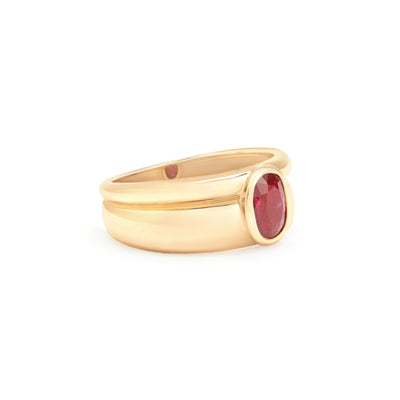 yellow gold ring with ruby center stone turned to see side detail on white background
