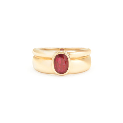 yellow gold ring with ruby center stone on white background