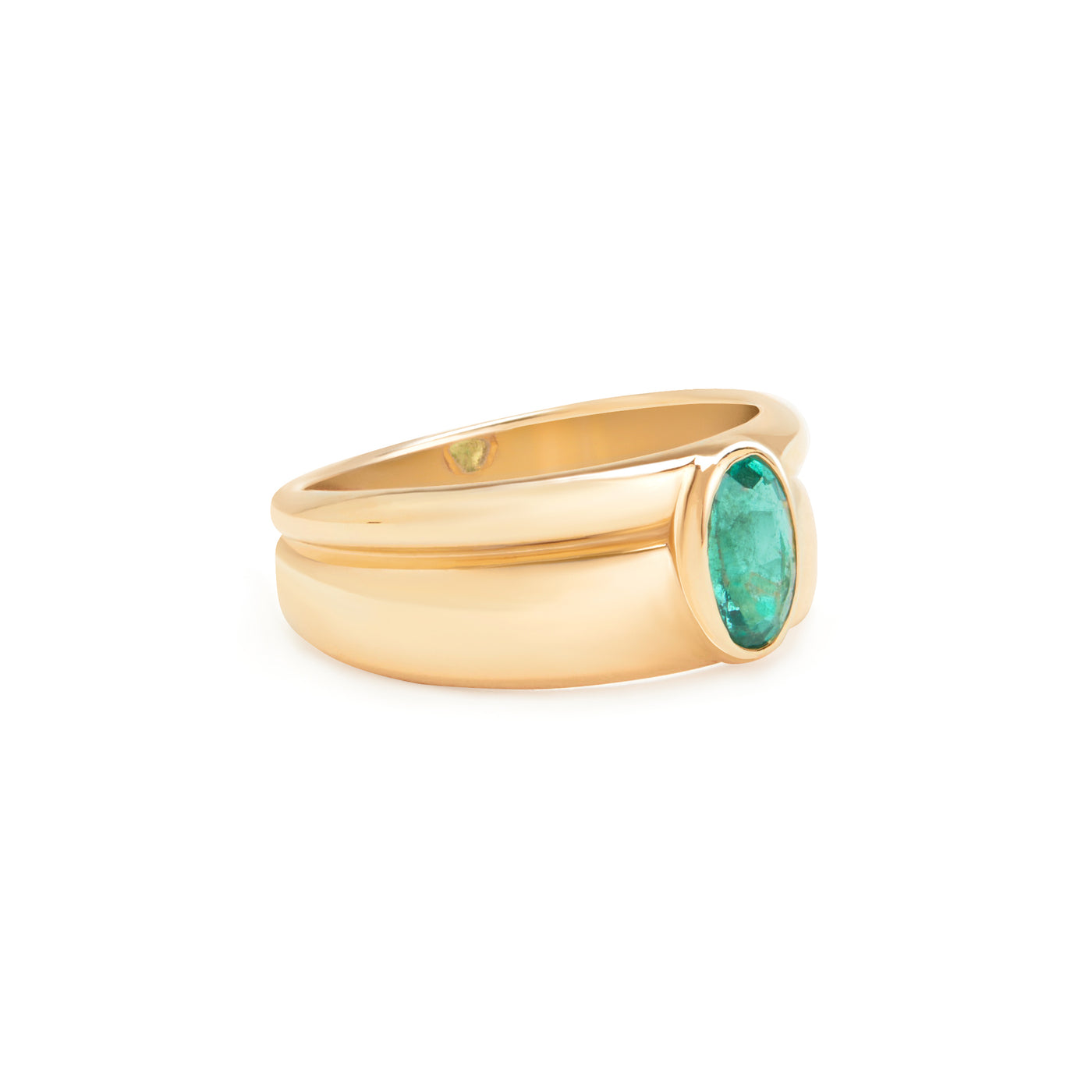 yellow gold ring with emerald center stone on white background