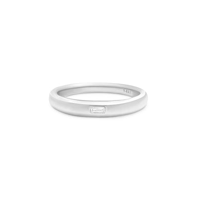 white gold ring with baguette diamond center stone on white background