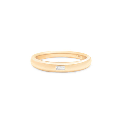 yellow gold ring with baguette diamond center stone on white background