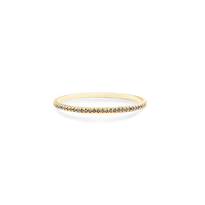 14 Karat Yellow Gold Ring with Black Diamonds in One Row Laying Flat On Flat White Table