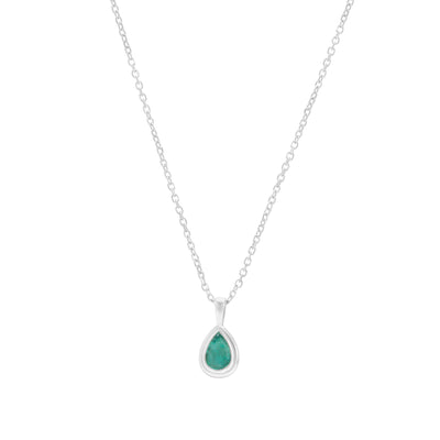 Emerald pear shaped white gold pendant on cable chain on white background