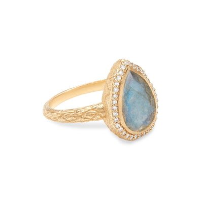 14 Karat Yellow Gold Ring with Pear Shaped Labradorite Stone with Halo of White Diamonds Turned for Side Detail Against White Background