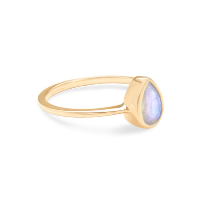 14 Karat Yellow Gold Ring with Pear Shaped Moonstone Against White Background Turned for Side View