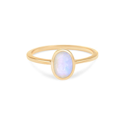 14 Karat Yellow Gold Ring with Oval Shaped Moonstone Stone Against White Background