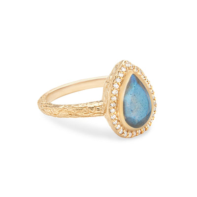 14 Karat Yellow Gold Ring with Pear Shaped Labradorite Stone with Halo of White Diamonds Against White Background Turned for Detail