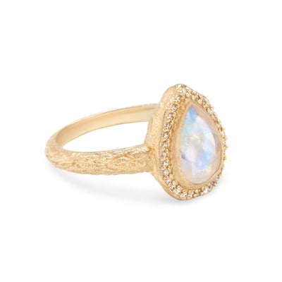 14 Karat Yellow Gold Ring with Pear Shaped Moonstone with Halo of White Diamonds Against White Background Turned for detail