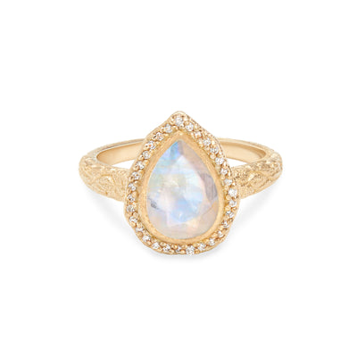 14 Karat Yellow Gold Ring with Pear Shaped Moonstone with Halo of White Diamonds Against White Background
