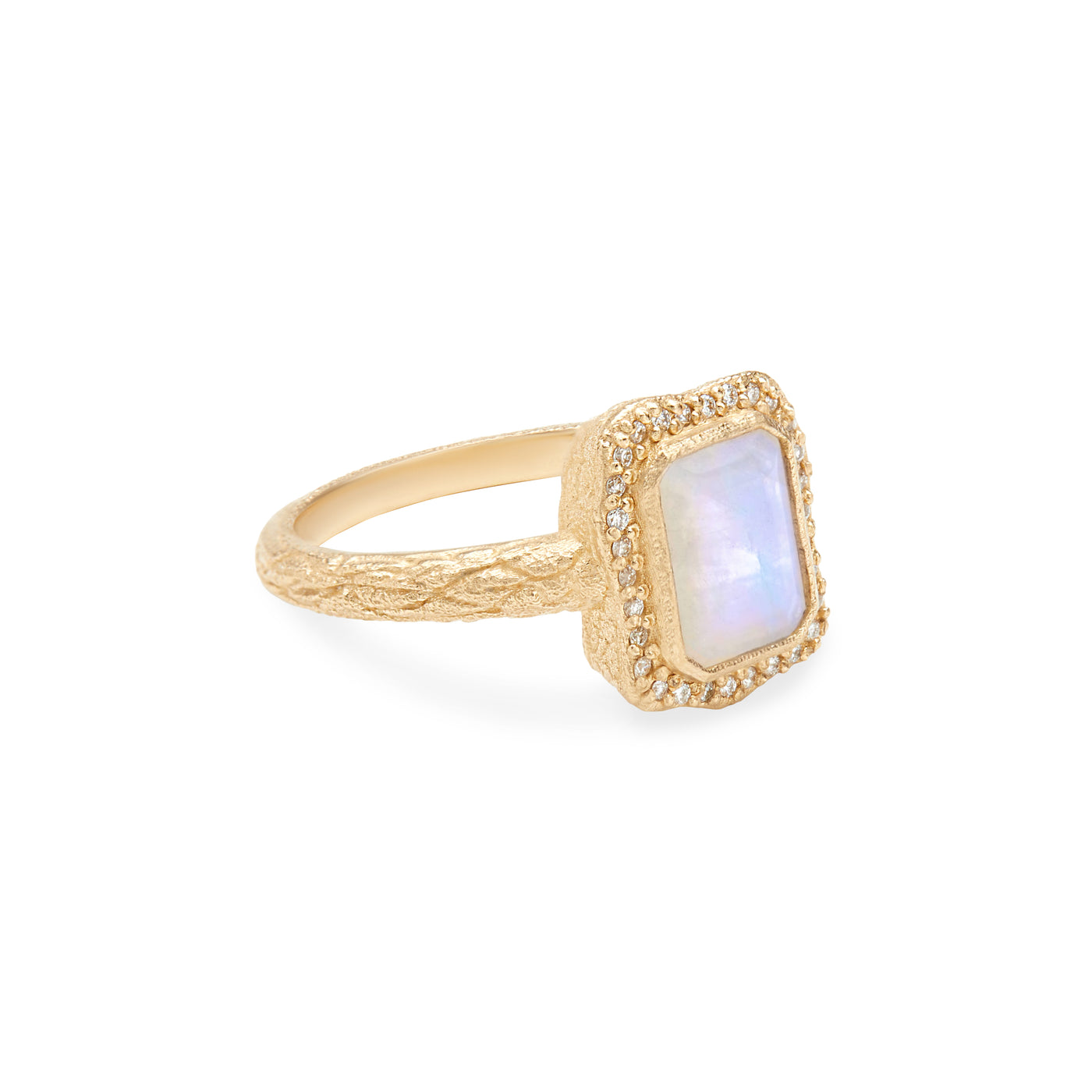 14 Karat Yellow Gold Ring with Rectangle Shaped Moonstone with Halo of White Diamonds Against White Background turned for detail