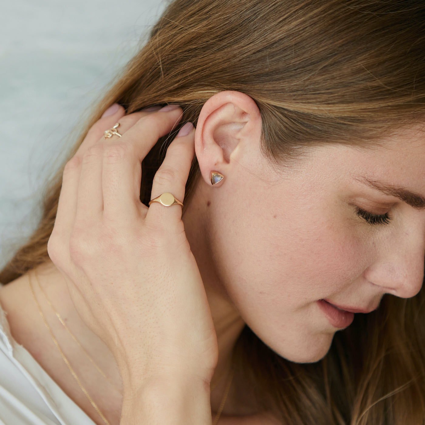 Model wearing a yellow gold flat face signet rig on her pinky.
