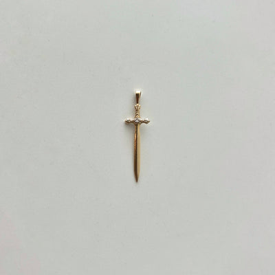 Gold sword-shaped pendant on a light gray background